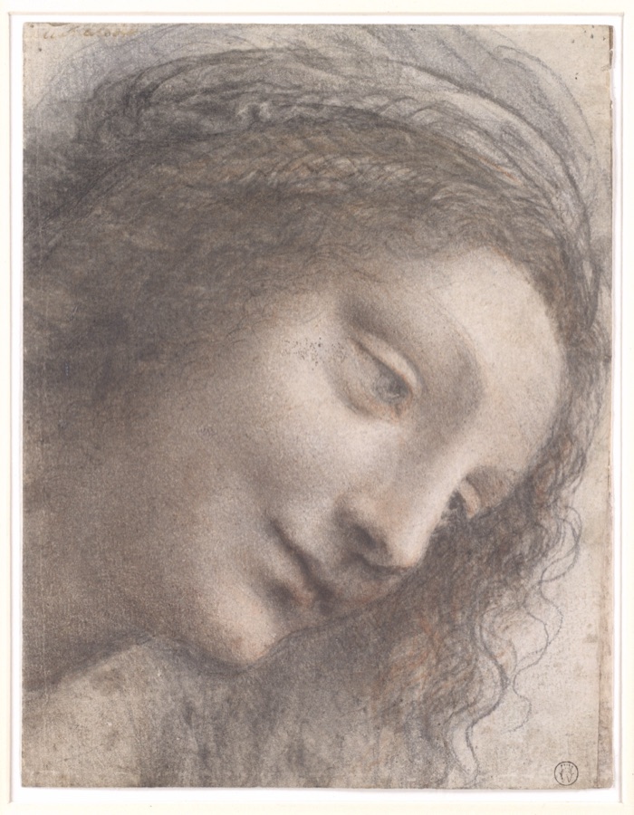 A chalk drawing of a young woman’s head tilted down to the right, eyes lowered. The face is modelled in soft, smoky black and red chalk with no hard outlines; loose curls fall at the right.