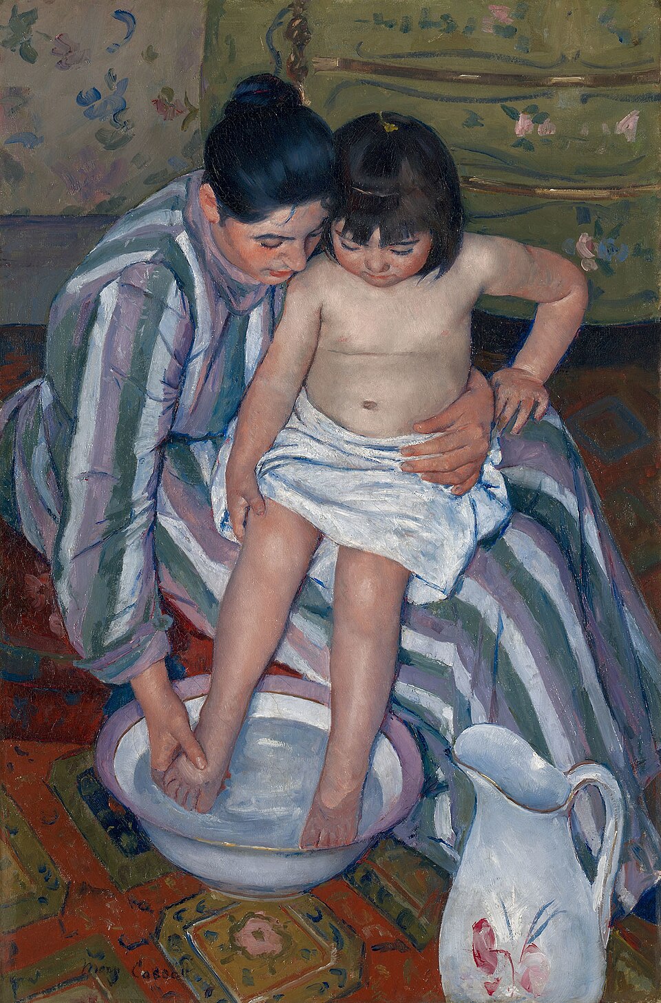 Seen from above, a woman in a striped dress supports a child on her lap and washes a small foot in a basin. A white pitcher stands beside them.